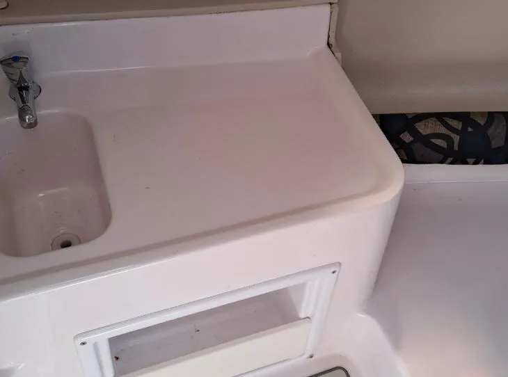 Slide: The Image of 2011 Pro-Line 23 Express boat interior with sink and storage area. - 12