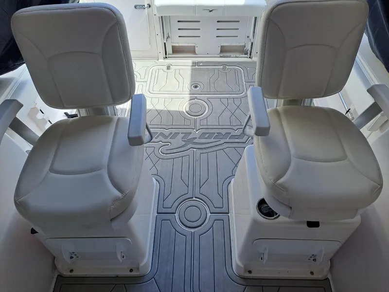 Slide: The Image of 2011 Pro-Line 23 Express boat interior with two white cushioned seats. - 8