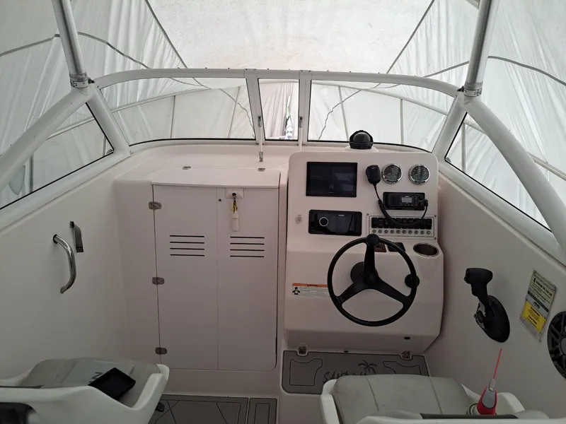 Slide: The Image of 2011 Pro-Line 23 Express boat cockpit with steering wheel and control panel. - 9
