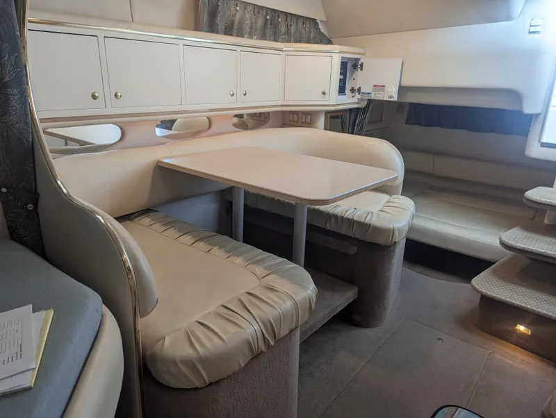 Slide: The Image of Interior of 2000 Sea Ray 310 Sundancer with dining area and seating. - 12
