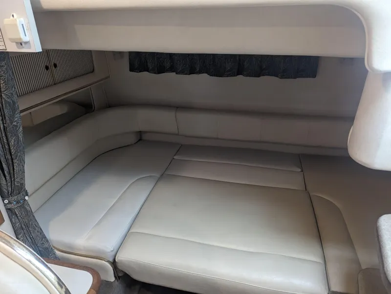 Slide: The Image of Interior cabin of 2000 Sea Ray 310 Sundancer with beige seating and curtains. - 15