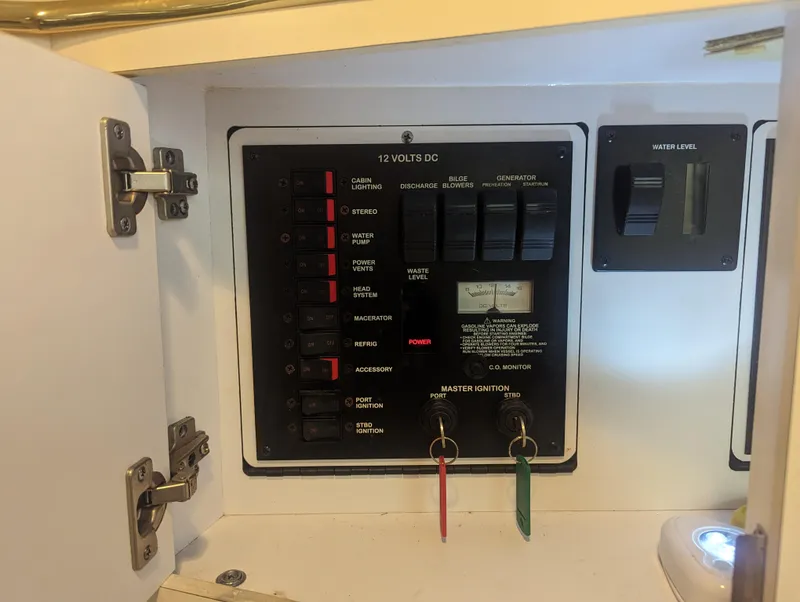 Slide: The Image of Electrical panel of a 2000 Sea Ray 310 Sundancer boat, showing switches and controls. - 16