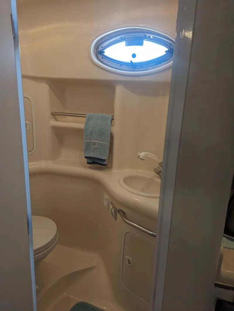 Slide: The Image of Bathroom interior of 2000 Sea Ray 310 Sundancer yacht with sink and porthole. - 18