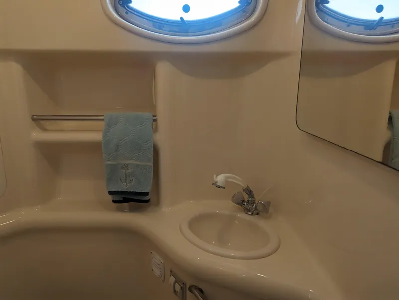 Slide: The Image of Bathroom interior of 2000 Sea Ray 310 Sundancer yacht with sink and towel. - 19