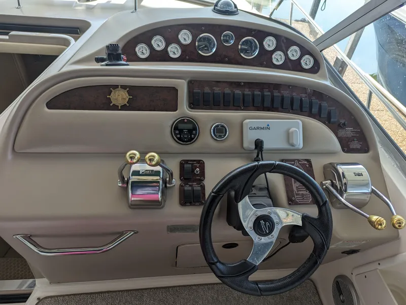 Slide: The Image of Dashboard of a 2000 Sea Ray 310 Sundancer boat with steering wheel and controls. - 25
