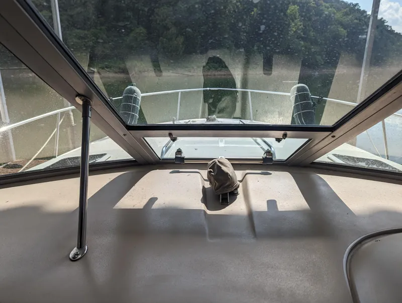 Slide: The Image of Interior view from a 2000 Sea Ray 310 Sundancer boat, showing the front deck and windshield. - 26