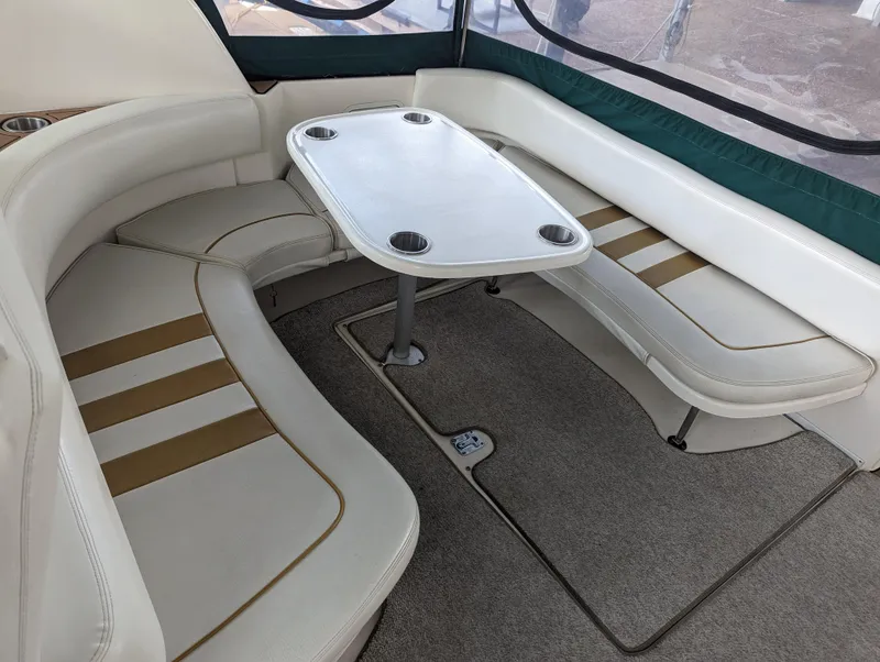 Slide: The Image of Interior seating area of 2000 Sea Ray 310 Sundancer boat with table. - 28
