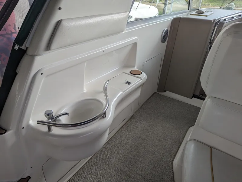 Slide: The Image of Interior of 2000 Sea Ray 310 Sundancer with sink and seating area. - 29
