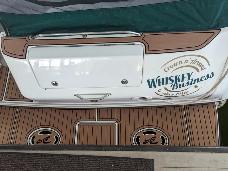 Slide: The Image of Sea Ray 310 Sundancer 2000 boat with "Whiskey Business" decal on wooden deck. - 33