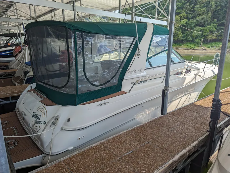 Slide: The Image of 2000 Sea Ray 310 Sundancer docked with green canopy in marina. - 34