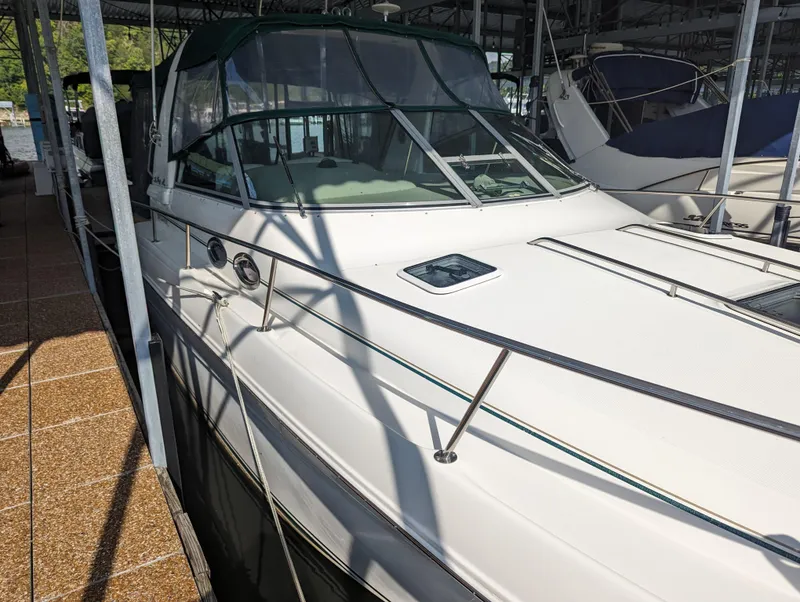 Slide: The Image of 2000 Sea Ray 310 Sundancer docked in marina, side view. - 36