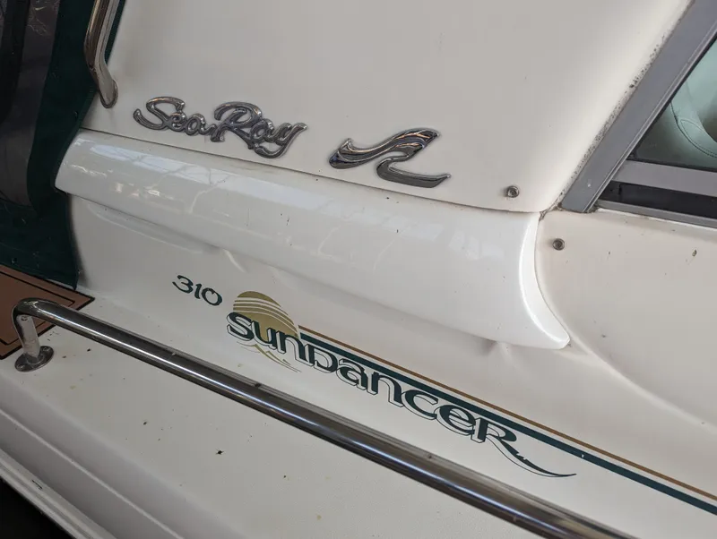 Slide: The Image of Close-up of 2000 Sea Ray 310 Sundancer boat logo and branding. - 37