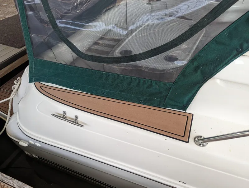 Slide: The Image of Sea Ray 310 Sundancer 2000 boat with green canopy and deck details. - 38