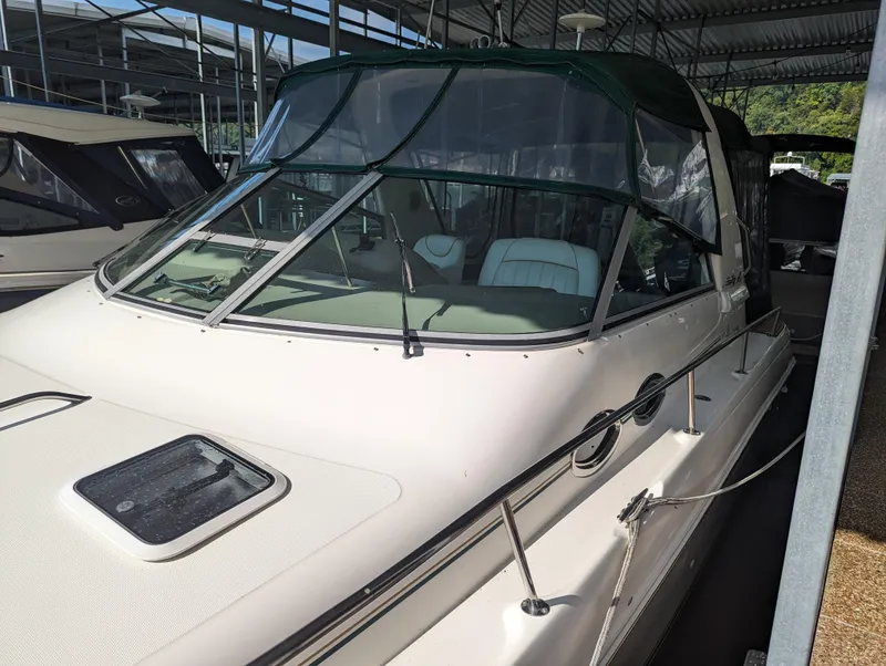 Slide: The Image of 2000 Sea Ray 310 Sundancer boat docked under a covered marina. - 41