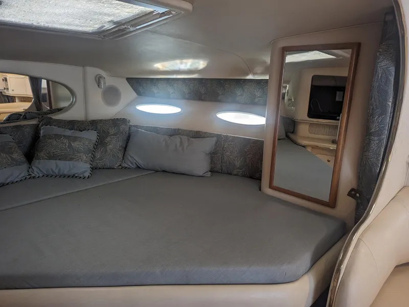 Slide: The Image of Interior of 2000 Sea Ray 310 Sundancer with cozy bed and mirror. - 8