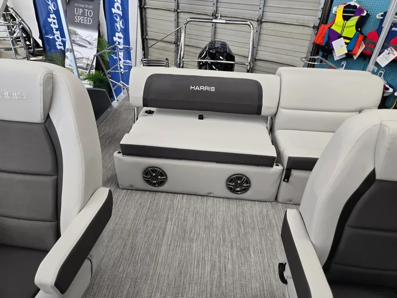 Slide: The Image of 2025 Harris Cruiser 210 interior with gray seating and speakers. - 11