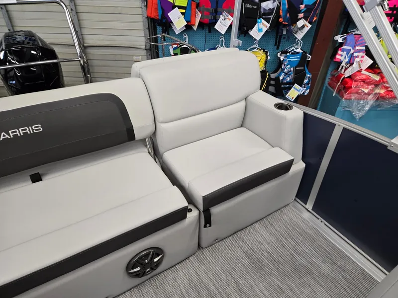 Slide: The Image of 2025 Harris Cruiser 210 boat interior with gray seating and cup holder. - 22