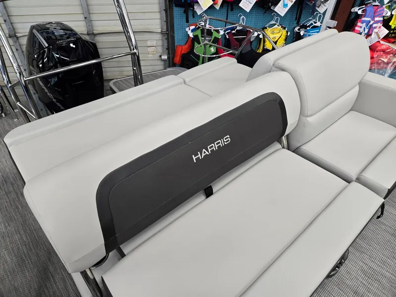 Slide: The Image of 2025 Harris Cruiser 210 boat interior with gray seating in showroom. - 23