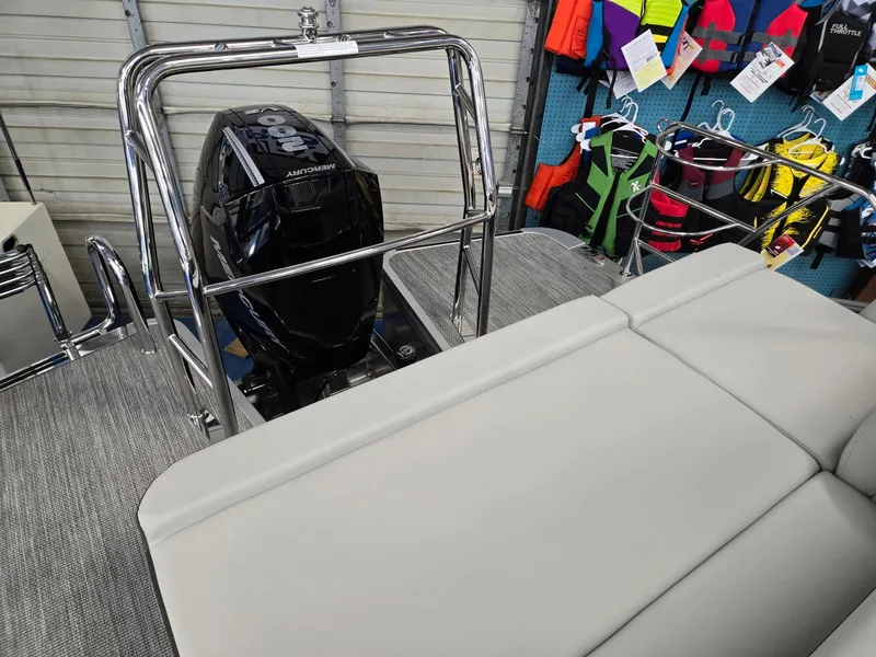 Slide: The Image of 2025 Harris Cruiser 210 boat with Mercury outboard motor and life jackets in background. - 24