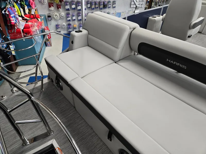 Slide: The Image of 2025 Harris Cruiser 210 boat interior with gray seating and chrome railing. - 26