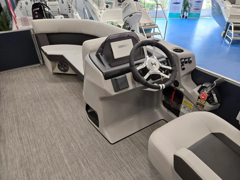 Slide: The Image of 2025 Harris Cruiser 210 boat interior with modern steering console and seating. - 31
