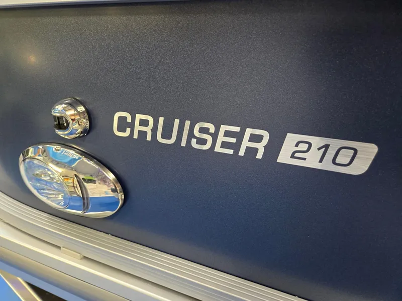 Slide: The Image of 2025 Harris Cruiser 210 boat emblem with chrome detailing. - 35