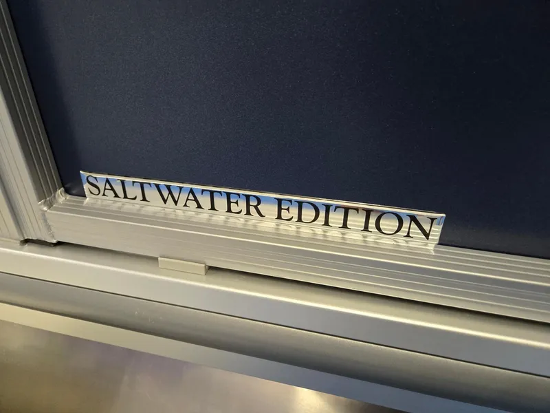 Slide: The Image of 2025 Harris Cruiser 210 Salt Water Edition label on a metallic surface. - 36