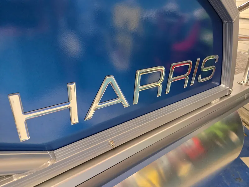Slide: The Image of Close-up of 2025 Harris Cruiser 210 logo on blue background. - 37