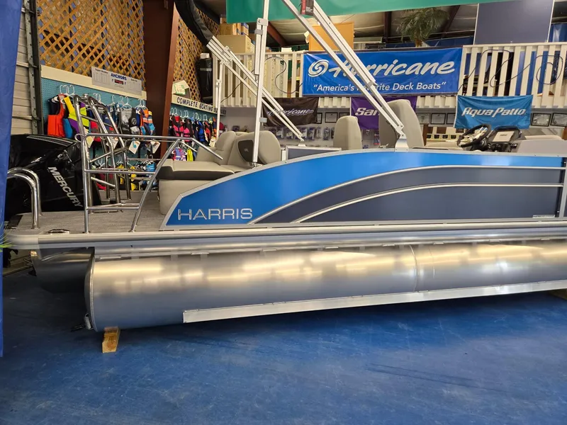 Slide: The Image of 2025 Harris Cruiser 210 pontoon boat displayed in showroom. - 4