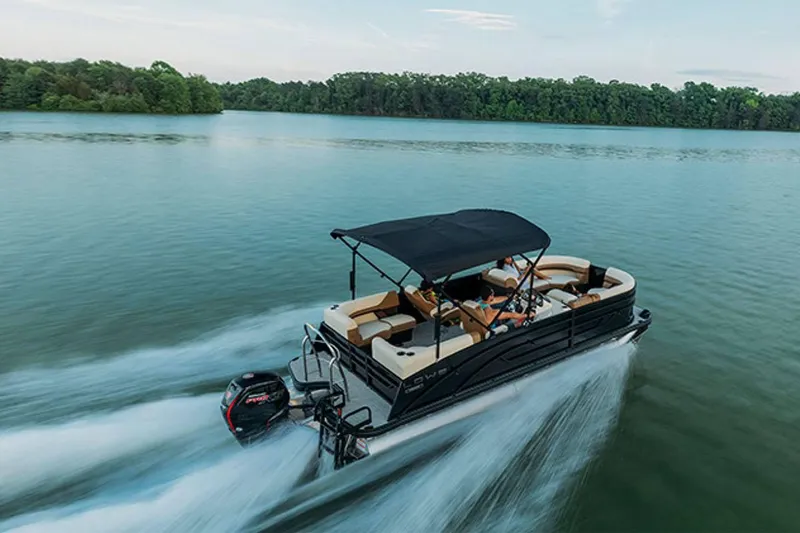 Slide: The Image of 2024 Lowe SS 210 WT pontoon boat cruising on a serene lake. - 15