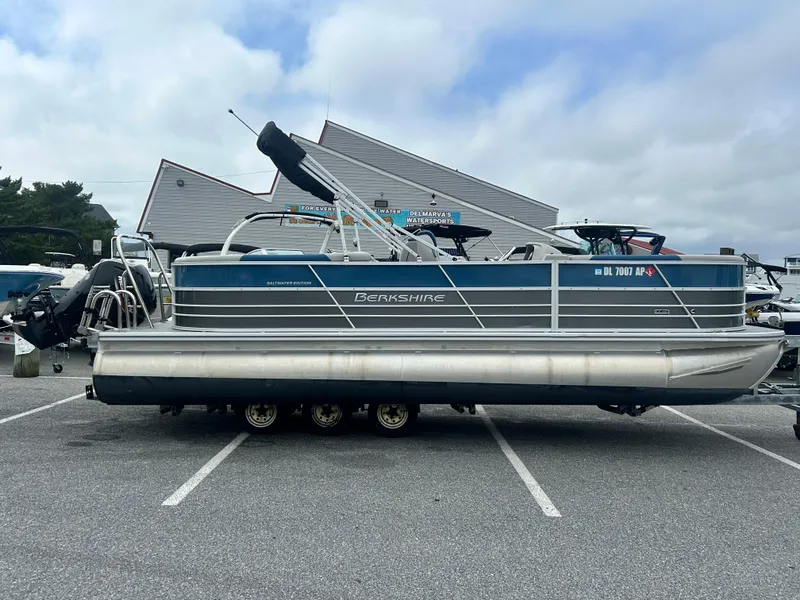 The Image of 2024 Berkshire 24RFX LE 2.75 pontoon boat parked in a marina lot. - 0
