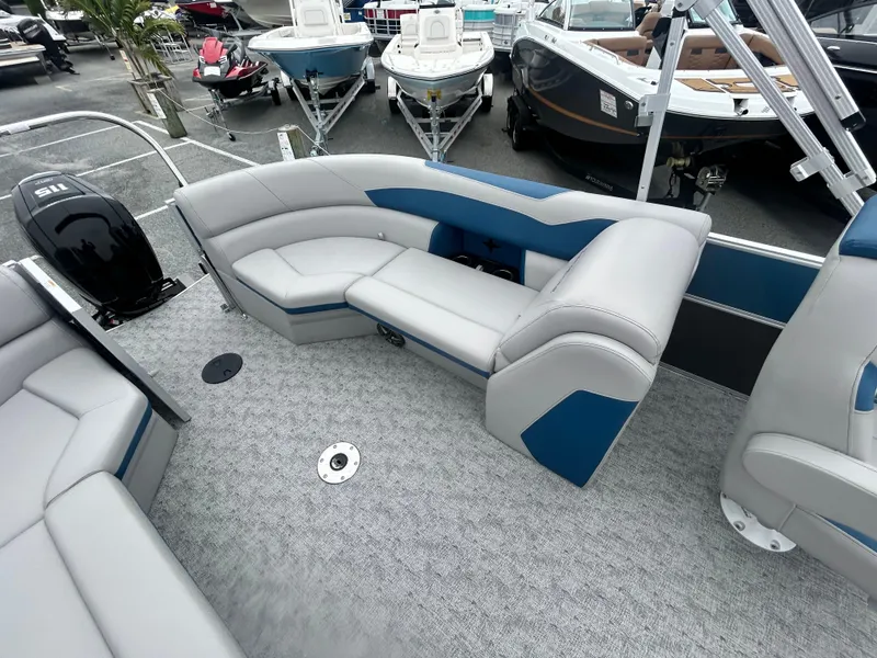 Slide: The Image of 2024 Berkshire 24RFX LE 2.75 pontoon boat interior with gray and blue seating. - 10