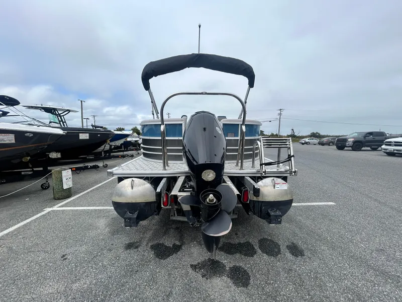 Slide: The Image of 2024 Berkshire 24RFX LE 2.75 pontoon boat, rear view in a parking lot. - 16