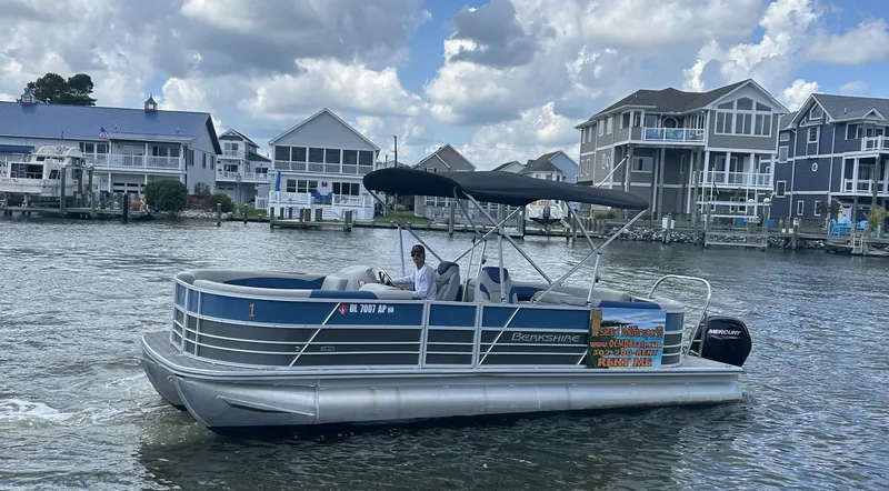 Slide: The Image of 2024 Berkshire 24RFX LE 2.75 pontoon boat cruising on a scenic waterfront. - 17