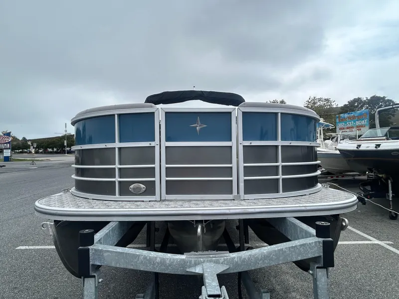 Slide: The Image of 2024 Berkshire 24RFX LE 2.75 pontoon boat on trailer, front view. - 2