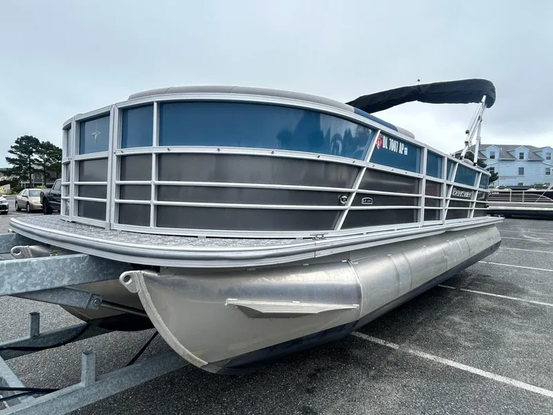 Slide: The Image of 2024 Berkshire 24RFX LE 2.75 pontoon boat on trailer in parking lot. - 3