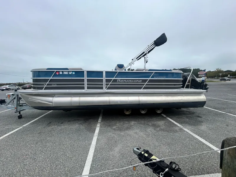 Slide: The Image of 2024 Berkshire 24RFX LE 2.75 pontoon boat parked in a lot. - 5