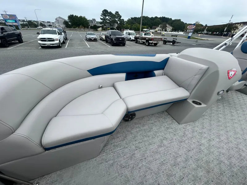 Slide: The Image of 2024 Berkshire 24RFX LE 2.75 pontoon boat interior with gray seating in a parking lot. - 7