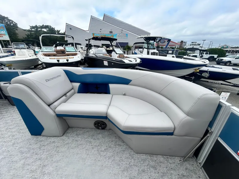 Slide: The Image of 2024 Berkshire 24RFX LE 2.75 pontoon boat with luxurious seating, docked at a marina. - 8