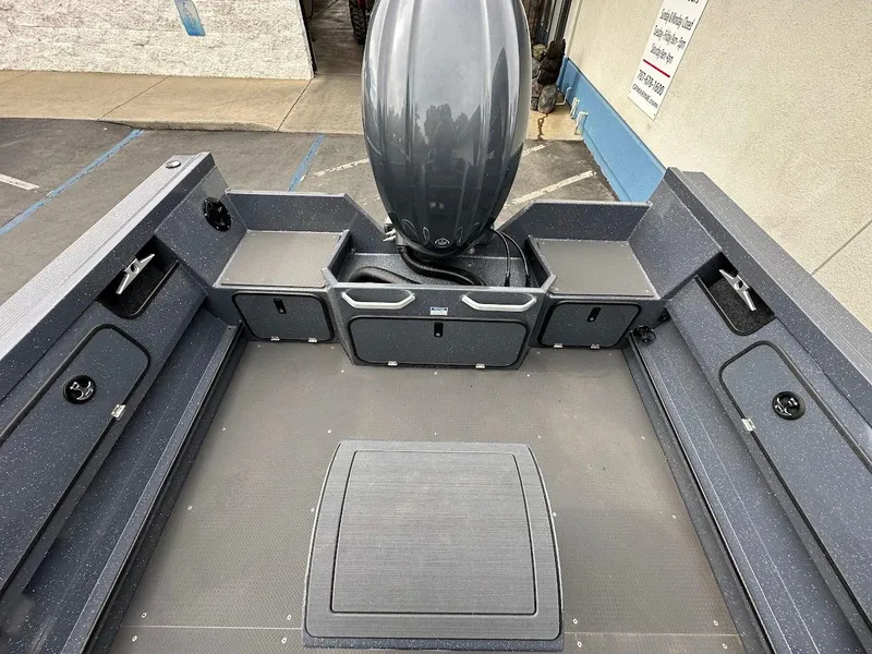 Slide: The Image of 2025 Duckworth 20 Advantage Access boat interior with storage compartments and motor. - 14