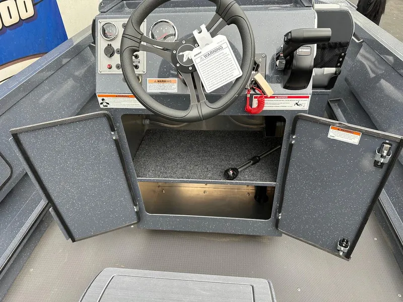 Slide: The Image of 2025 Duckworth 20 Advantage Access boat dashboard with open storage compartments. - 23