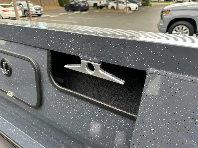 Slide: The Image of 2025 Duckworth 20 Advantage Access boat cleat detail in a parking lot. - 25