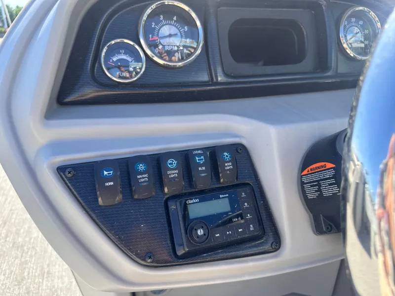 Slide: The Image of Control panel of 2024 Berkshire 24RFX LE 2.75 boat with gauges and switches. - 15