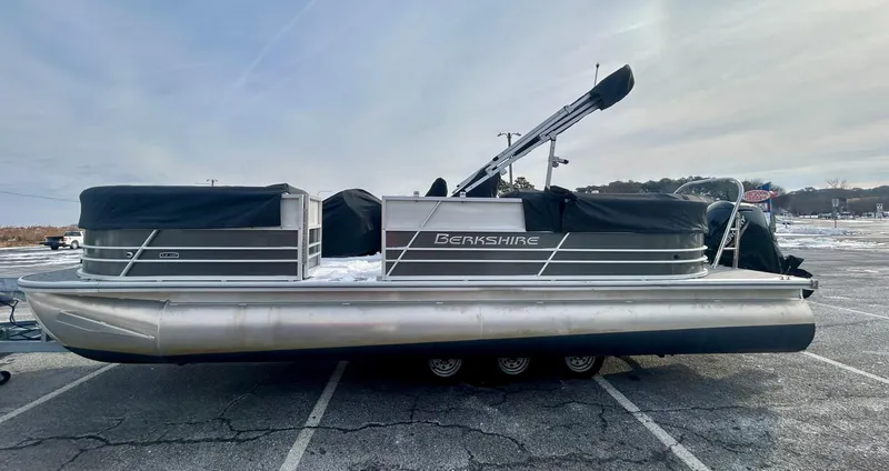 Slide: The Image of 2024 Berkshire 24RFX LE 2.75 pontoon boat parked on asphalt. - 3