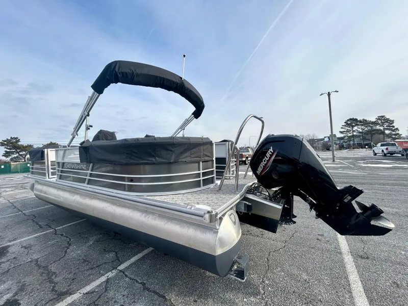 Slide: The Image of 2024 Berkshire 24RFX LE 2.75 pontoon boat with Mercury outboard motor in parking lot. - 4