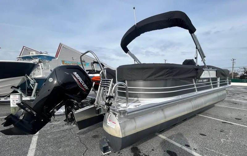Slide: The Image of 2024 Berkshire 24RFX LE 2.75 pontoon boat with Mercury outboard engine, parked outdoors. - 5