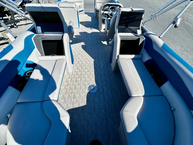 Slide: The Image of 2024 Berkshire 24RFX LE 2.75 pontoon boat interior with seating and steering console. - 11