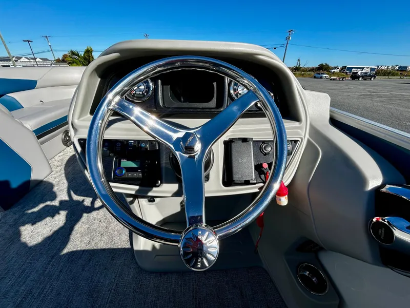 Slide: The Image of 2024 Berkshire 24RFX LE 2.75 boat steering wheel and dashboard in sunlight. - 12