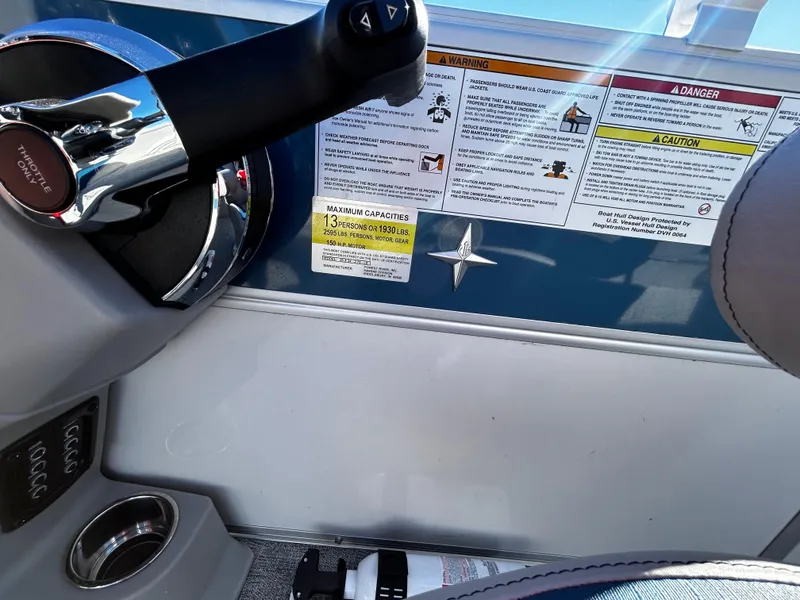 Slide: The Image of 2024 Berkshire 24RFX LE 2.75 boat dashboard with controls and safety warnings. - 13