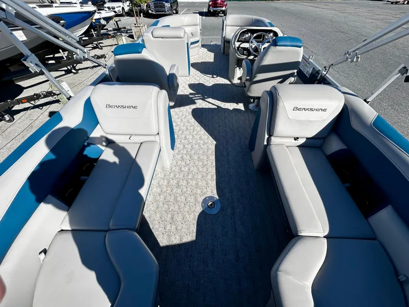 Slide: The Image of 2024 Berkshire 24RFX LE 2.75 pontoon boat interior with plush seating and steering console. - 15